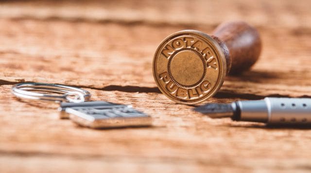 A bullet casing sitting on top of a wooden table.