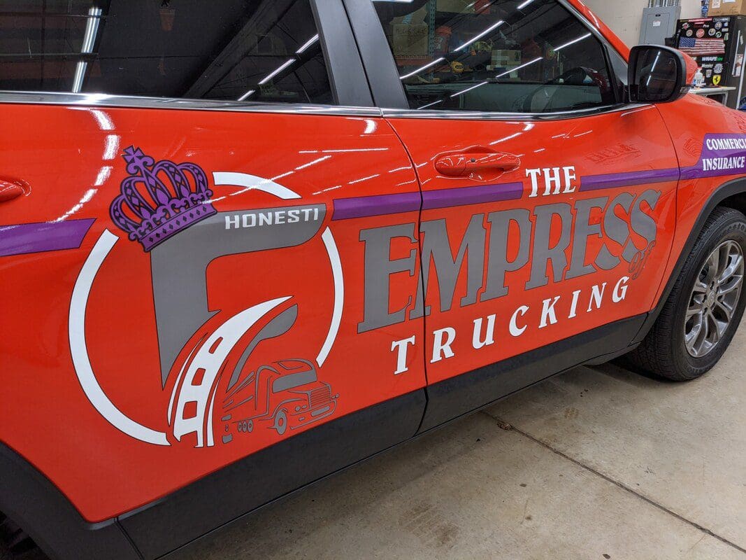 A red truck with the empress trucking logo on it.