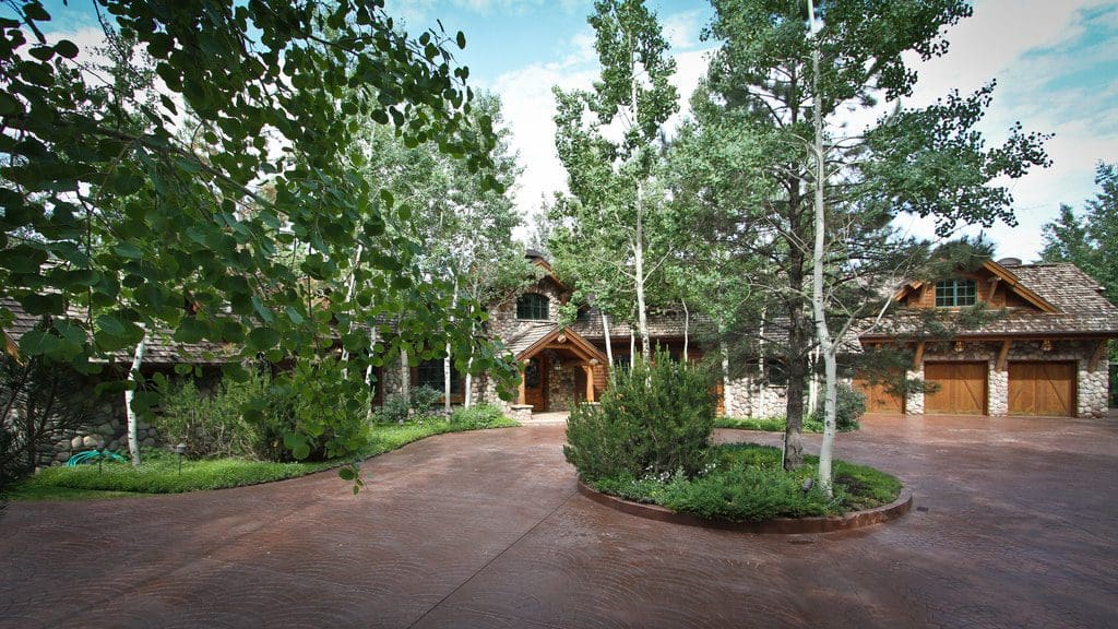 A large driveway with trees around it